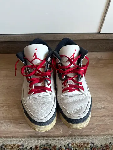 Used white and red Jordan sneakers, size unknown, good worn condition