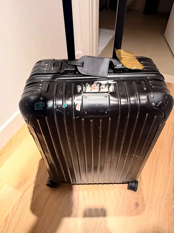 Genuine Rimowa Black hard-shell 4-wheel roller luggage - cabin plus  size.