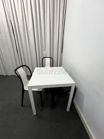 Small white dining table with two chairs - compact set