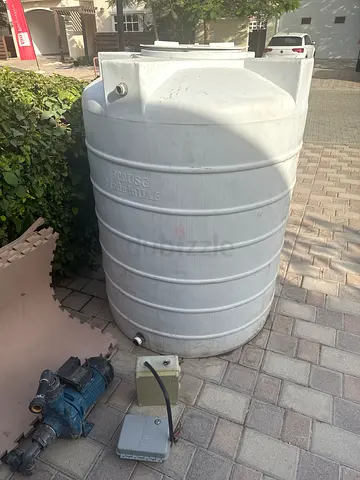 Large White Vertical Water Storage Tank with Pump (Used). Hunter irrigation also