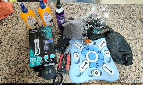 Mixed pet accessories bundle — training collar, treat puzzle, grooming  more
