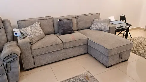 From owner, a very clean grey L-shaped sofa with two recliner seats like new from Home Centre