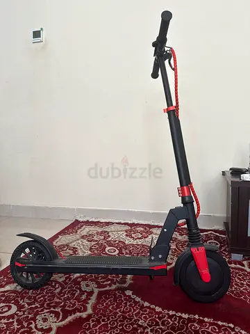 Foldable adult kick scooter with front suspension and handbrake