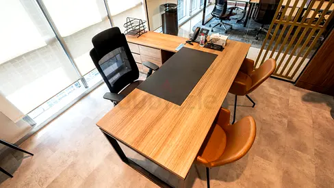 Modern wooden executive office desk with two guest chairs
