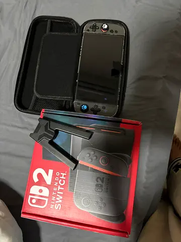 Nintendo Switch console with carrying case and Joy-Con grip — good condition screen protector - grip