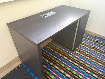 Dark wood office desk with storage drawer and cabinet