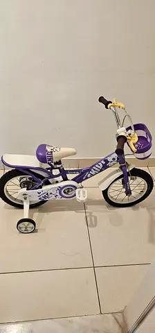 Purple childrens bike with training wheels - good condition