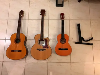 2 classical and 1 acoustic guitars with free guitar stand and 3 guitar bags