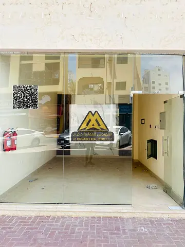 Shop for rent in Al Nakheel 1, second row from Ajman Corniche, prime and lively location with continuous activity, AED 33,000 per year, 4 installments