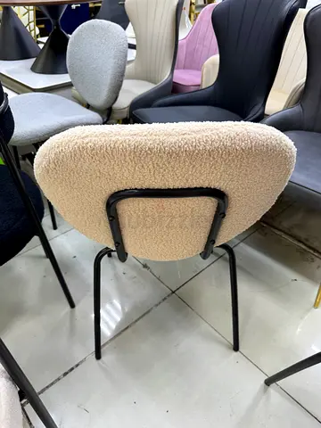 Cream boucle upholstered dining/side chair with black metal legs