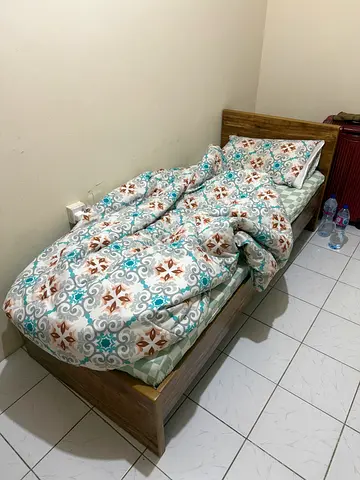 Wooden single bed with mattress
