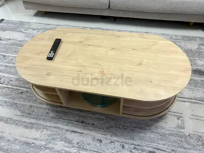 Light Wood Oval Coffee Table with Open Shelves and sliding doors