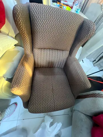 Comfortable brown upholstered wingback lounge chair – good condition