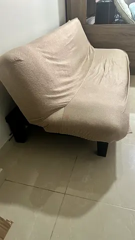 Compact beige two-seater sofa cum bed in good condition