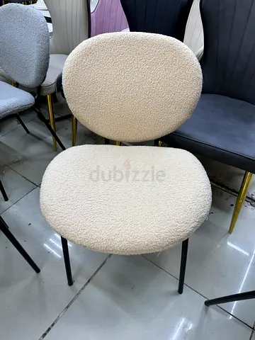 Cream boucle upholstered dining/side chair with black metal legs