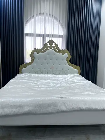 Ornate Upholstered King Size Bed with Carved Headboard