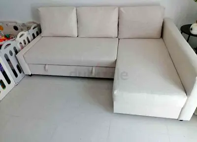 Light beige L-shaped sofa bed with storage chaise — good condition