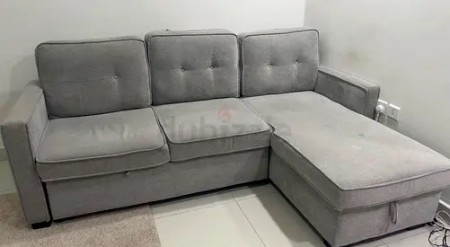 Light grey L-shaped fabric sofa with chaise (3-seater) bed