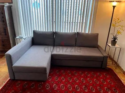 Dark grey L-shaped sofa bed with chaise - good condition