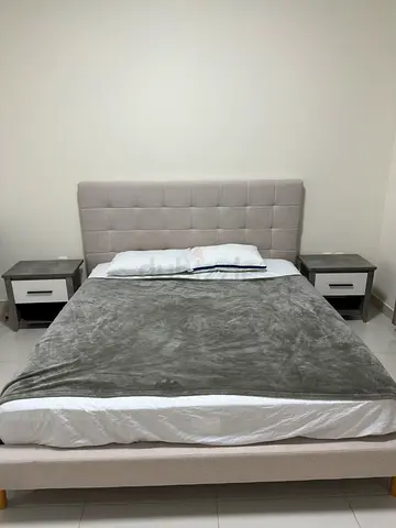 Queen fabric upholstered bed with mattress - light grey, along with 2 white and grey bedside tables
