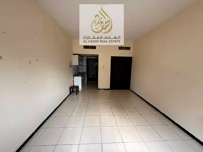 Large studio apartment with built-in wardrobes and a semi-separate kitchen in Al Rashidiya 3, near the Corniche.