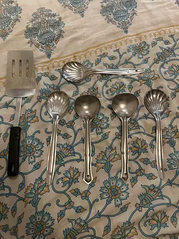 Set of stainless steel serving spoons and spatula