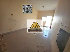 A spacious studio for annual rent in Al Hamidiya – Ajman, featuring a balcony with an open view an