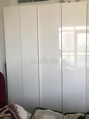 Three white glossy wardrobes