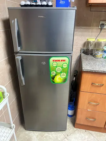 Silver double-door refrigerator with top freezer - good working condition