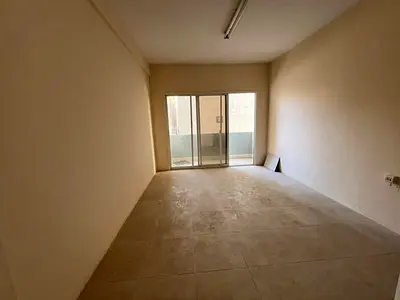 Balcony with an open view, spacious area, prime location, family-only building, close to Dubai exit