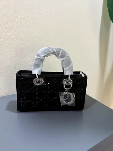 Small black quilted handbag with silver hardware