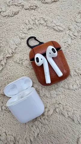 Apple air pods Two pairs of wireless earbuds with charging cases (used) - with leather case