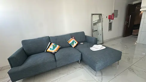 L-shaped blue fabric sofa with chaise - good condition with free coffee table and mirror