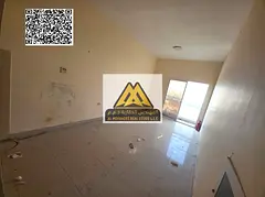A spacious studio for annual rent in Al Hamidiya – Ajman, featuring a balcony with an open view in