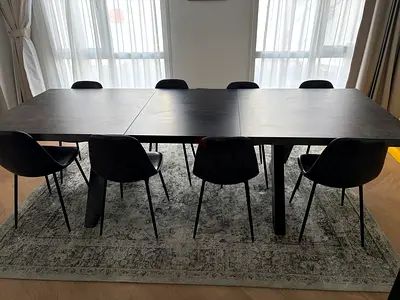 Modern extendable dining table with 8 chairs - dark finish from Chattels and More