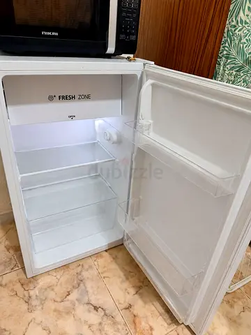 Compact single-door mini fridge in good working condition
