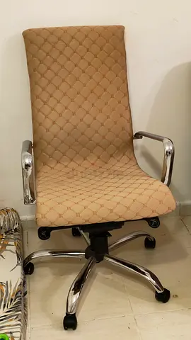 Beige High-Back Office Chair with Chrome Arms and Wheels