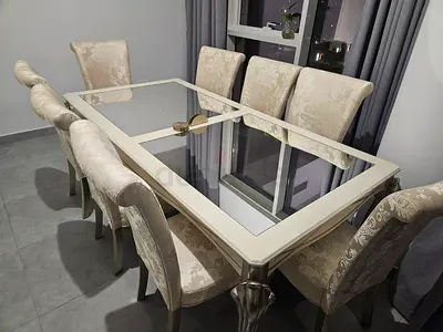 Beige 8-Seater Dining Table with Glass Top and Upholstered Chairs