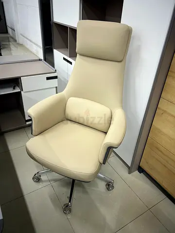 Cream ergonomic office chair with headrest and chrome base