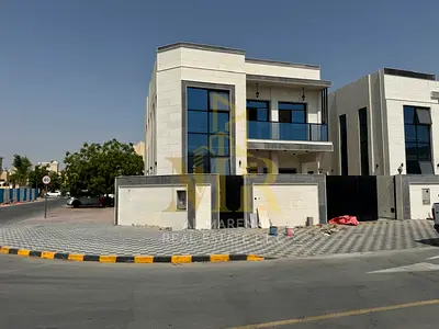 Villa in Al Rawda 1 area, corner location on two streets, central air conditioning, 5 master bedrooms, facing a mosque, modern design, close to all se