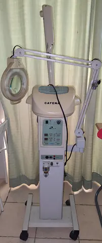 Used Catena medical/dermatology treatment unit with magnifying lamp on stand