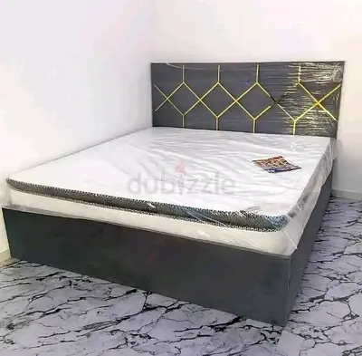 Grey upholstered double bed with geometric headboard (with mattress)