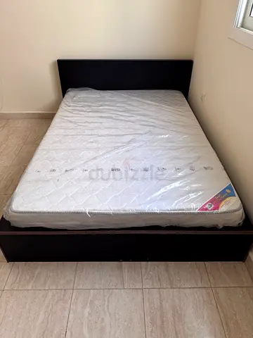 Queen bed frame with mattress — dark wood, good condition
