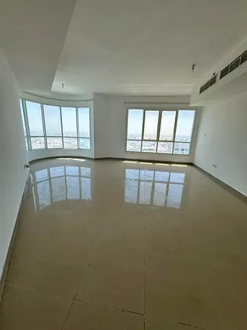 With free parking and one month free, the largest 4-bedroom, 2-living apartment with a balcony and open view is available for annual rent in Sharjah.