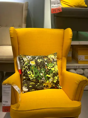 Bright Yellow Wingback Armchair with Decorative Cushion