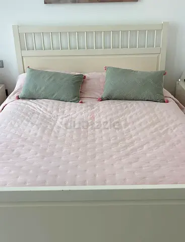 White wooden IKEA double bed frame with headboard and matching nightstands