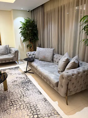 Light grey tufted velvet 3-seater sofa with cushions