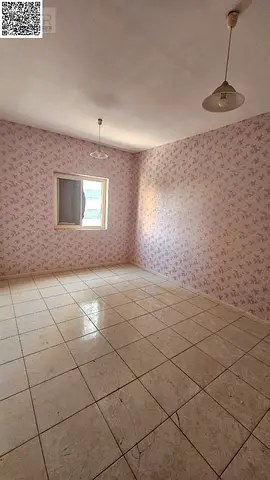 A room and a hall for annual rent in Ajman, spacious with a balcony.