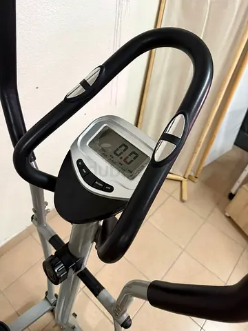 Elliptical exercise machine with seat, hand pulse sensor, and LCD screen, for home use