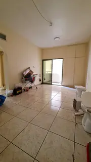 2-bedroom family apartment with central AC, balcony, and built-in wardrobes in Al Mujarrah, near all